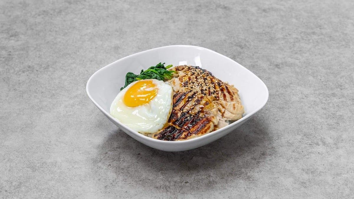 Glazed grilled chicken over rice with a fried egg, spinach and sesame